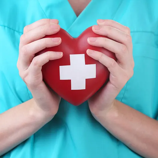 Healthcare worker holding a heart